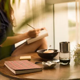 image of a person writing in a notebook