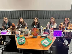 Group of men and women sitting behind a long table