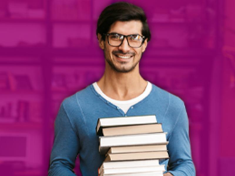 a man holding a stack of books