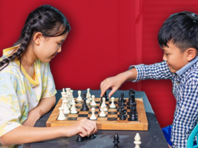 two children playing chess
