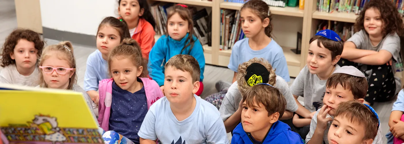 Goup of children listening to a story time at the library