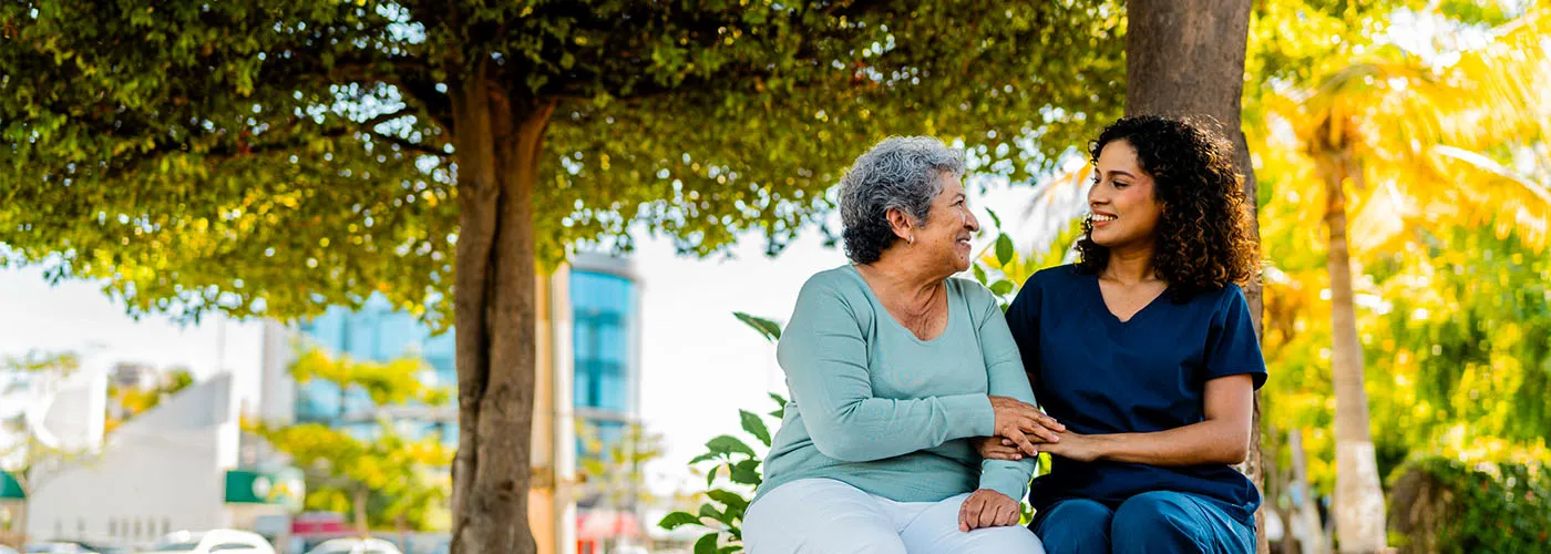 Photo of two women sitting in a park