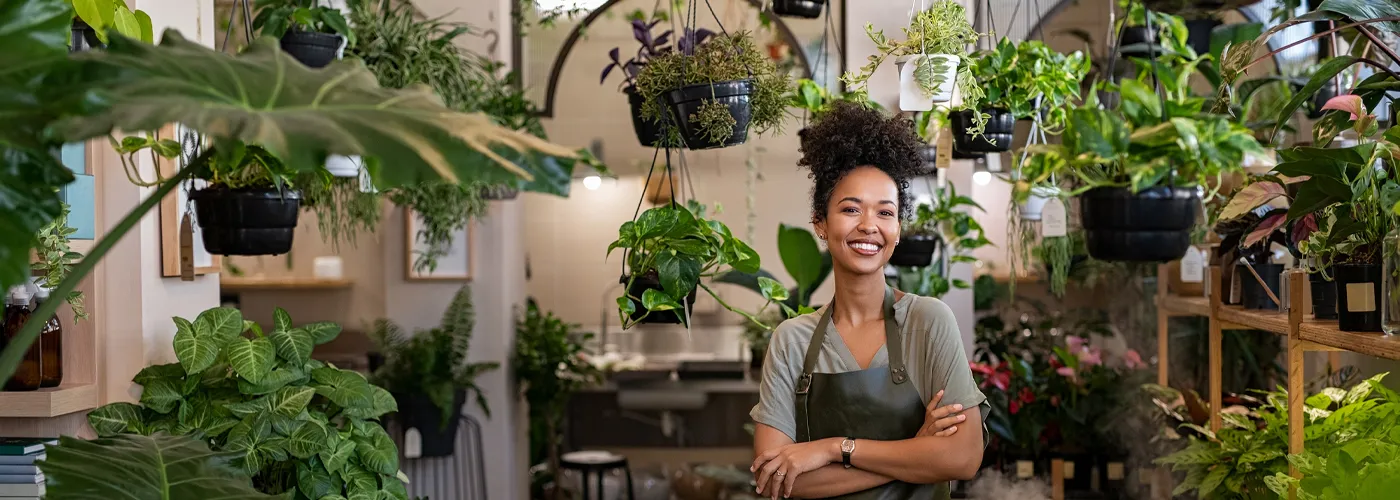 a woman standing in her plant shop