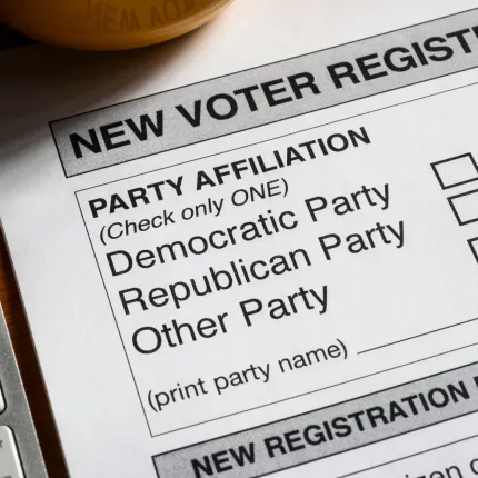 Picture of the voter registration form laying next to a keyboard.