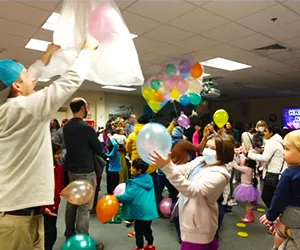 photo of the Library's Noon Year's Eve event, with a a balloon release and children having fun.
