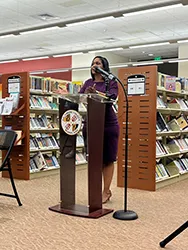 photo of a woman speaking at a podium