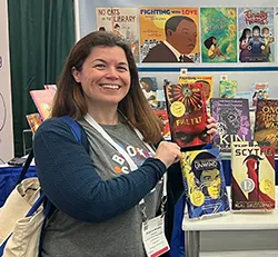 photo of a woman holding up a book