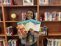 Photo of the battle of the books winner holding books