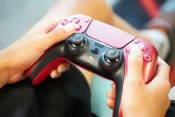 a child's hands holding a game controller